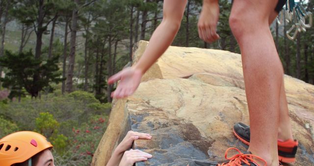 Climber Assisting Another Climber on Rocky Cliff - Download Free Stock Images Pikwizard.com