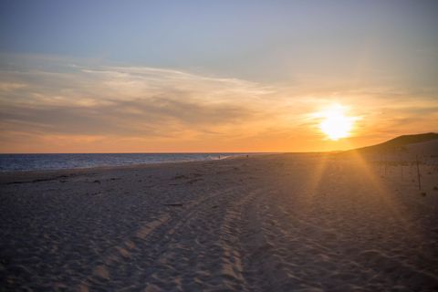 Tranquil Beach at Sunset with Soft Golden Sky