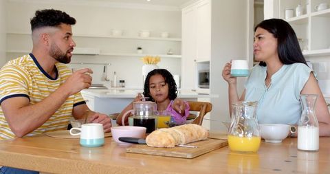 Family Sharing Breakfast at Modern Home Kitchen Table