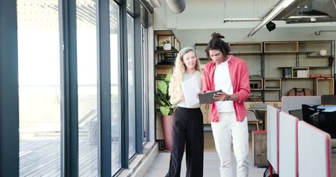 Colleagues collaborating in modern open office space