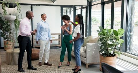 Diverse Colleagues Collaborating Joyfully in Stylish Office