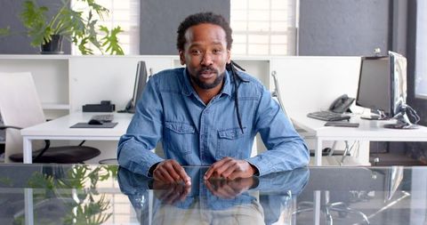 Professional Businessman Wearing Denim Shirt in Modern Office Setting