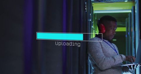 It technician uploading data in server room
