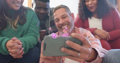 Friends sharing augmented reality overlay on smartphone, laughing and interacting together