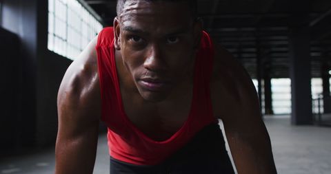 Determined Athlete Ready to Sprint in Industrial Space - Download Free Stock Images Pikwizard.com