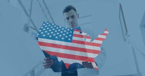 Doctors Discussing Records with USA Flag Overlay for Patriotism in Healthcare