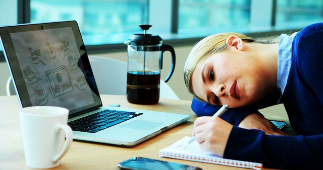 Young Woman Looking Depressed While Studying With Laptop and Notepad - Download Free Stock Images Pikwizard.com