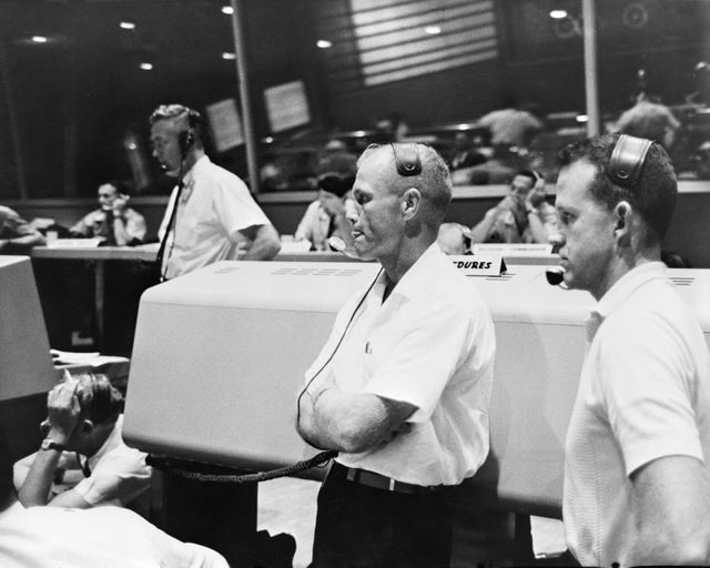 S61-03829 (21 July 1961) --- View of the Mission Control Center at Cape Canaveral during the Mercury-Redstone 4 (MR-4) mission. Astronauts John Glenn (left) and L. Gordon Cooper (right) act as spacecraft communicators (CAPCOM). Photo credit: NASA