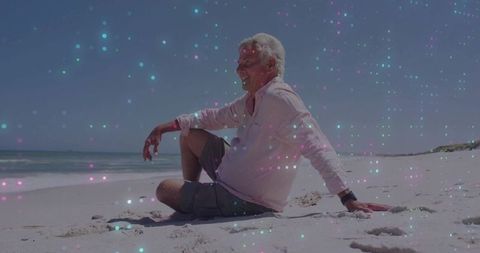 Relaxed Senior Enjoying Tranquil Beach with Colorful Bokeh