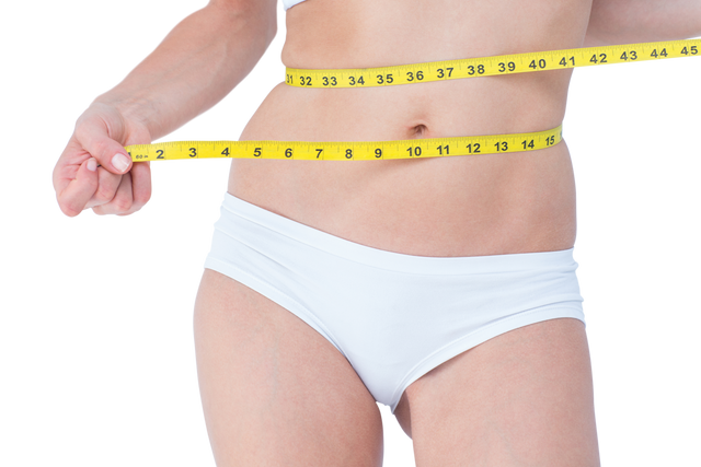 Close-up transparent background image of woman measuring her waist with a yellow measuring tape. This visual is perfect for use in content related to fitness, health, weight loss goals, diet tips, slimming advertisements, and promoting healthy lifestyle campaigns. It effectively illustrates proficiency in body measurement and self-care routines.