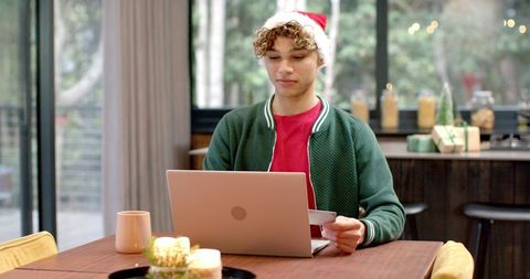 Male Wearing Santa Hat Shopping Online at Festive Home