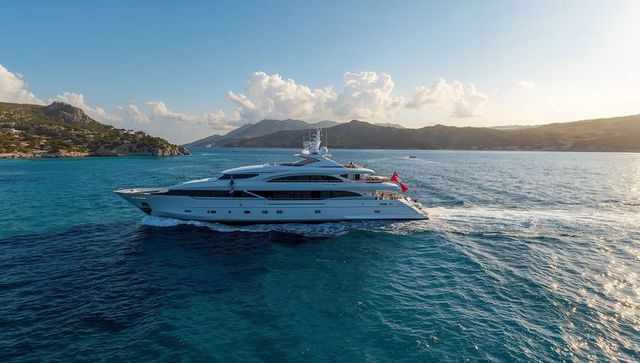 Luxury Yacht Cruising Calm Turquoise Waters by Scenic Shoreline