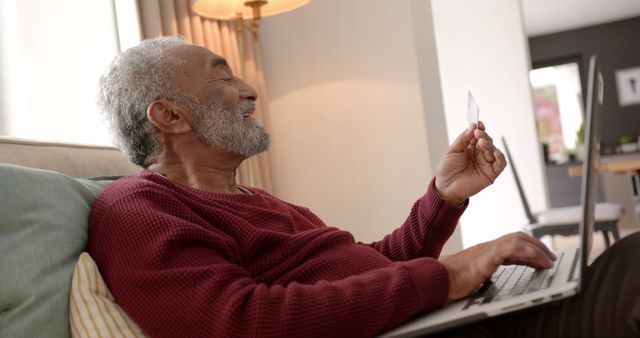 Elderly Man Smiling While Online Shopping with Credit Card on Laptop - Download Free Stock Images Pikwizard.com