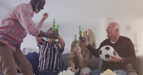 Friends Cheering with Beers Watching Soccer Match at Home