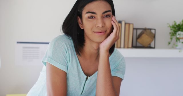 Portrait of biracial gender fluid person looking at camera and smiling at home - Download Free Stock Photos Pikwizard.com
