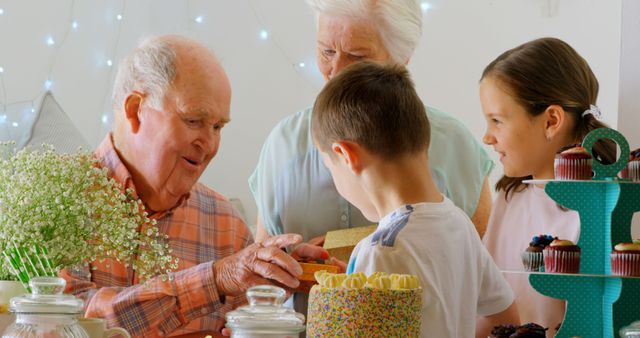 Grandchildren Giving Gifts to Happy Grandfather at Celebration - Download Free Stock Images Pikwizard.com