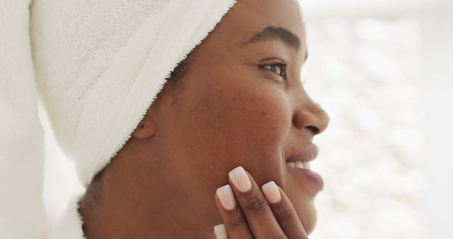 Image of happy african american woman in robe moisturizing face - Download Free Stock Photos Pikwizard.com