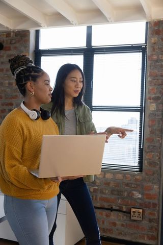 Diverse Female Colleagues Engaging in Creative Collaboration