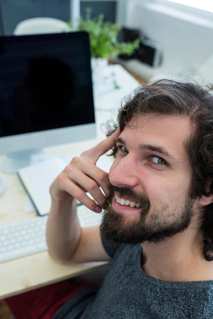 Portrait of male graphic designer smiling in office