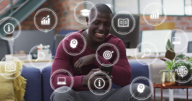 A man using his smartphone seated in a modern workspace with various digital icons floating around him, representing different concepts such as learning, communication, and technology. This image can be used for topics related to modern work environments, digital learning, tech innovation, multitasking, and lifestyle.