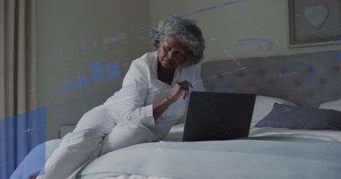 Senior Woman Engaged with Digital Data Insights on Laptop