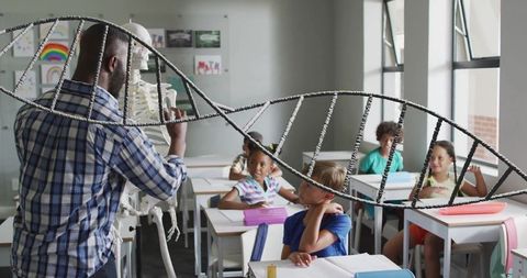 Teacher demonstrating dna structure to engaged classroom