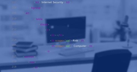 Blurred office workspace with desktop monitor and html code overlay for internet security