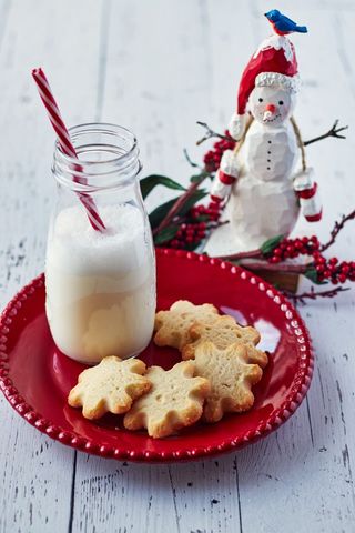Festive Snowflake Cookies with Milk and Snowman Decor