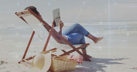 Woman Relaxing on Beach with Tablet and Beach Gear