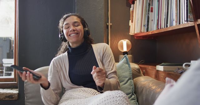 Woman Relaxing on Couch with Headphones and Smartphone - Download Free Stock Images Pikwizard.com