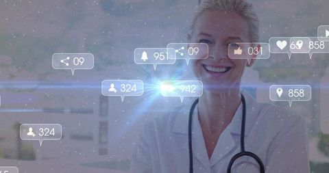 Smiling mature doctor wearing white coat and stethoscope with healthcare notifications