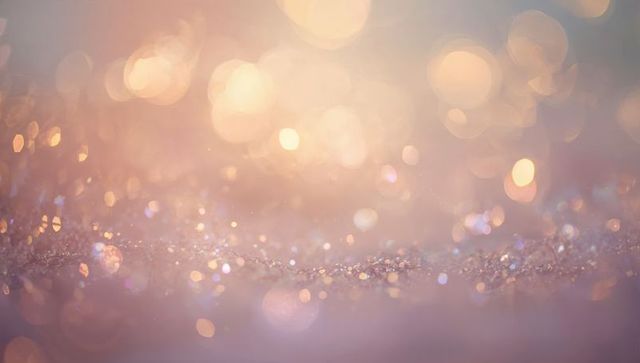 Pastel glitter bokeh closeup with warm golden light and iridescent shimmer