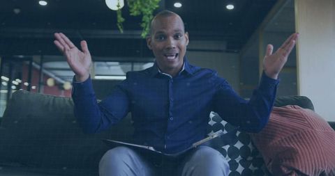 Businessman making energetic presentation on office sofa