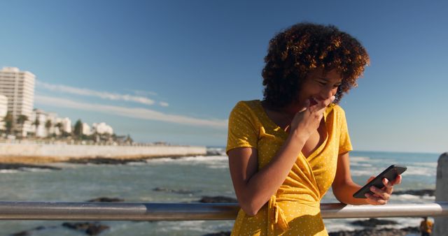 Woman in Yellow Dress Using Smartphone by Waterfront - Download Free Stock Images Pikwizard.com