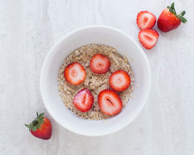 Nutritious Oatmeal Breakfast With Fresh Strawberries on White Marble Background - Download Free Stock Photos Pikwizard.com