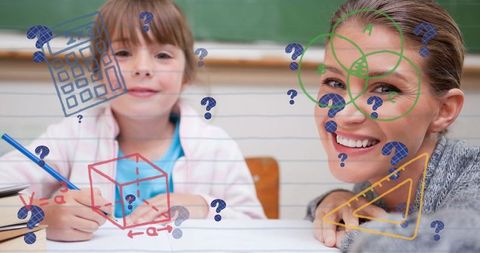 Teacher assisting schoolgirl with mathematical concepts