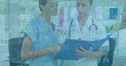 Female Doctors Discussing Medical Records with Financial Data Overlay