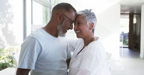 Mature couple sharing heartwarming moment in modern home