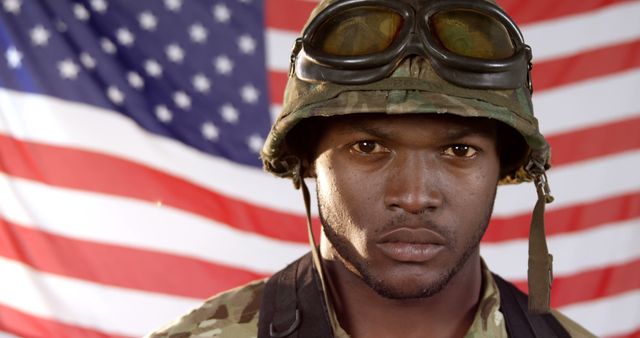 Portrait of african american male soldier on flag of usa background with copy space. Army, american patriotism and defence concept, unaltered.