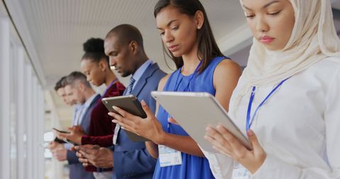 Diverse professionals using tablets in modern office