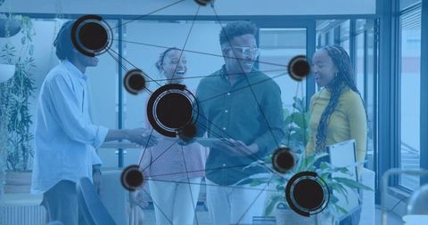 Diverse team collaborating in modern glass office with digital network overlay and greenery