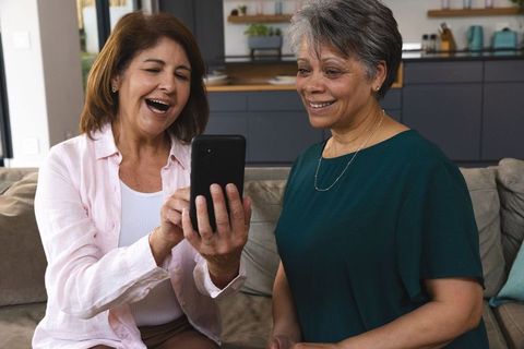 Diverse Female Friends Sharing Moments on Smartphone