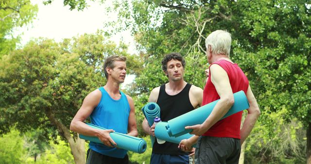 Group of Men Holding Yoga Mats in Park - Download Free Stock Images Pikwizard.com