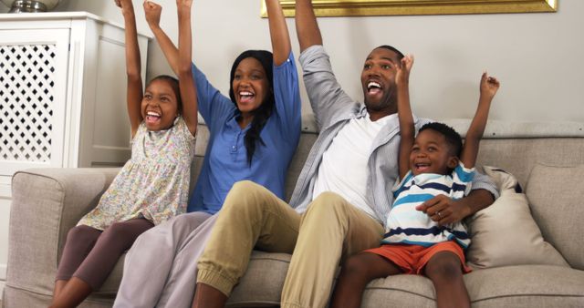 Joyful Family Celebrating Together on Living Room Sofa - Download Free Stock Photos Pikwizard.com