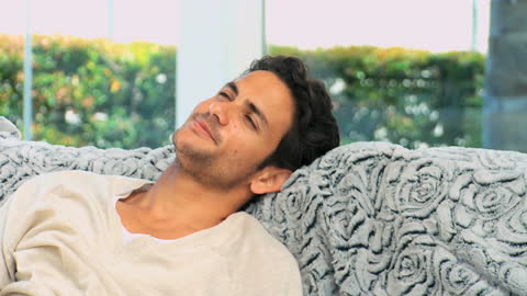 Relaxed Man Enjoying Red Wine on Comfortable Sofa