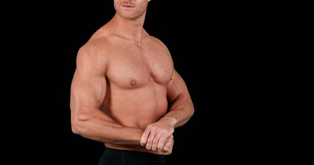 A muscular Caucasian man is showcased against a black background, with copy space - Download Free Stock Photos Pikwizard.com