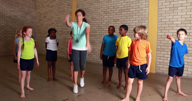 Energetic Kids in Gym Class with Enthusiastic Instructor - Download Free Stock Images Pikwizard.com