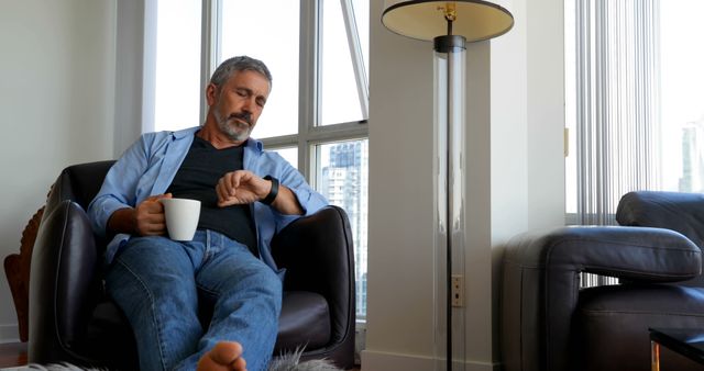 Senior Man Relaxing at Home with Coffee in a Modern Apartment - Download Free Stock Images Pikwizard.com