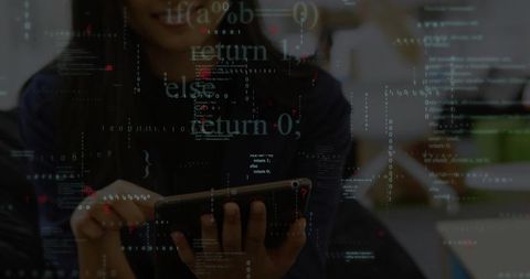 Developer analyzing code with tablet in office