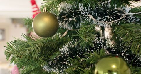 Christmas Tree Decorated with Green Baubles and White Flocking